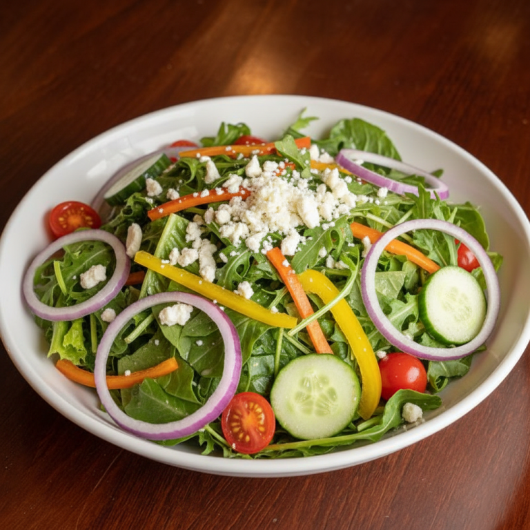 Salad at A Slice Of Heaven Chicago A vibrant salad with mixed greens, tomatoes, cucumbers, bell peppers, red onion, and feta cheese.